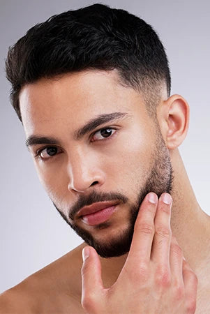 Man posing with beard care products – White Wolf men’s grooming
